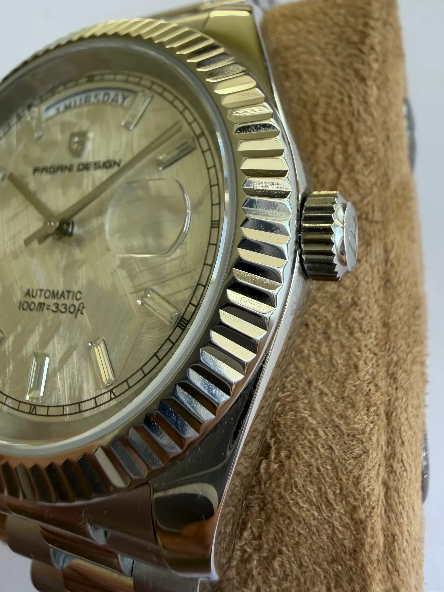 The fluted bezel and screw-down crown up close.
