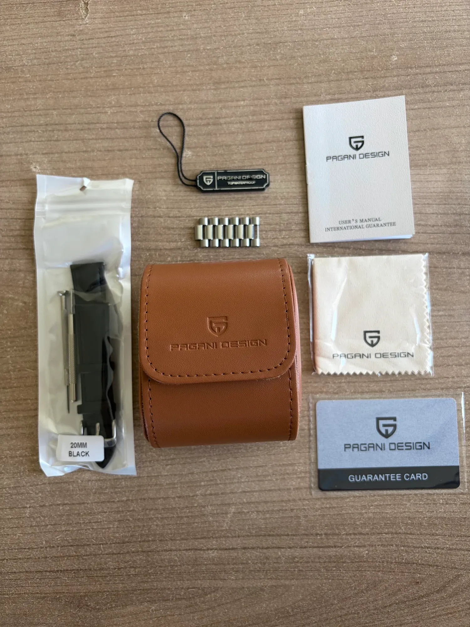 Everything in the box laid out flat, with the watch pouch.