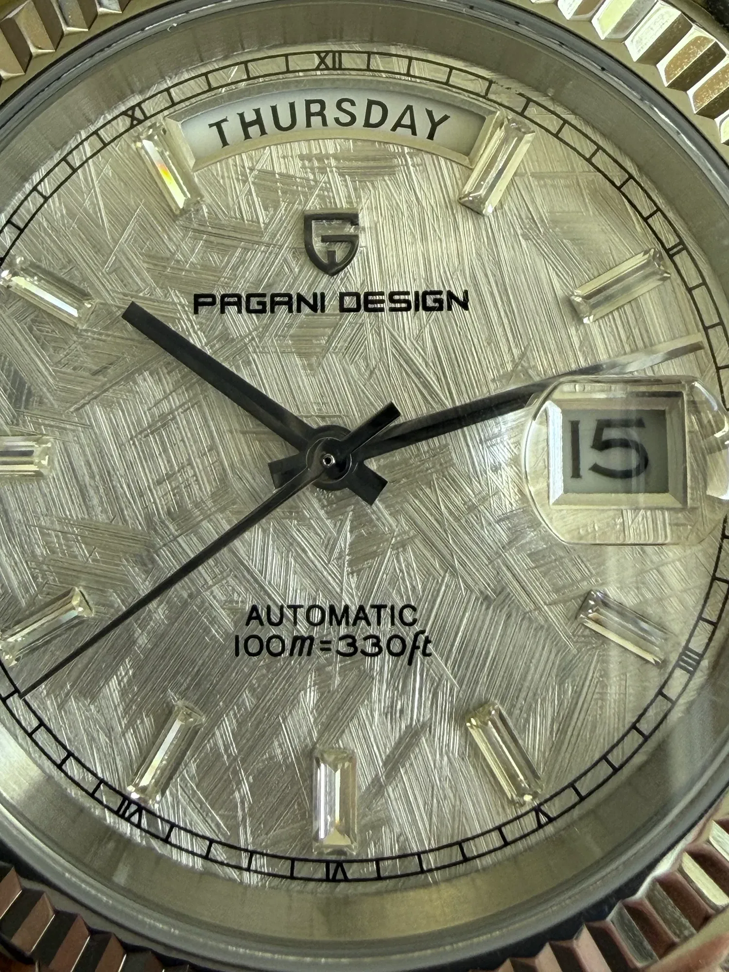 Close-up of the meteorite-textured silver dial and baguette hour markers.