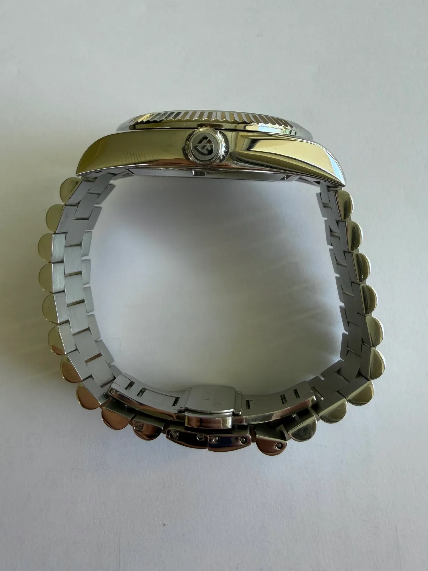 The PD-1783 on its side, showing the case profile, crown and bracelet.